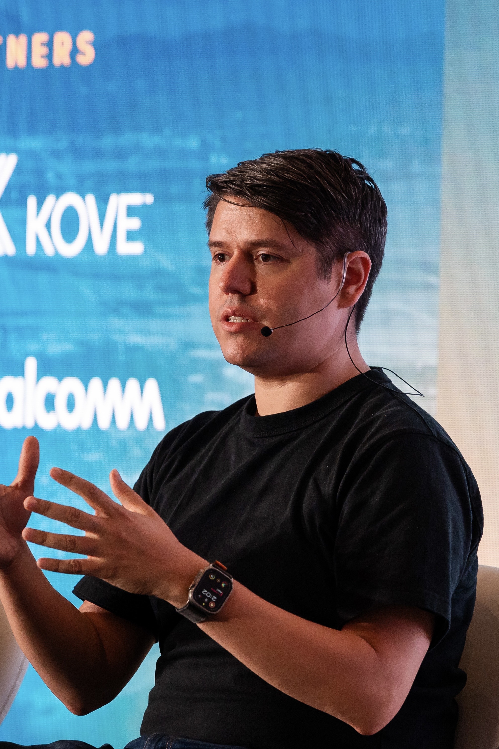 Daniel speaking on stage